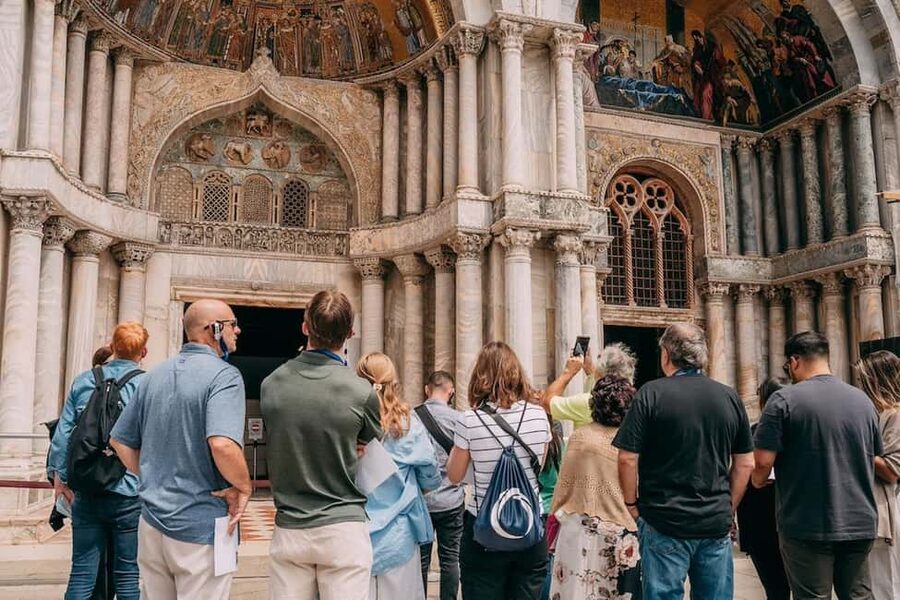 St. Mark's Basilica Tour with Priority Entrance + Gondola - Meeting your guide beneath the blue clock tower