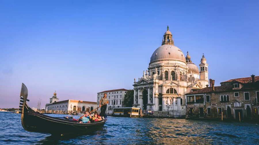 Venice: Gondola Ride under the Bridge of Sighs with Audio Guide App - Boarding the shared gondola near Punta della Dogana